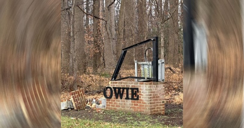 A picture of a demolished brick structure with the letters OWIE still in tact on the front